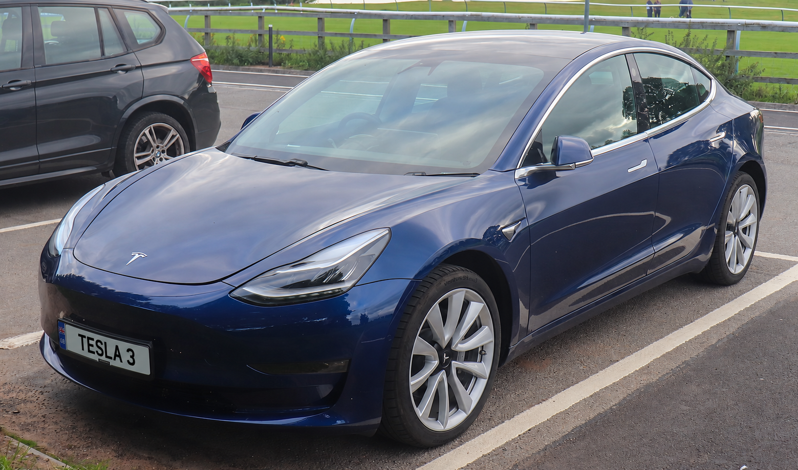 Blue 2019 Tesla Model 3 with TESLA 3 on the front plate